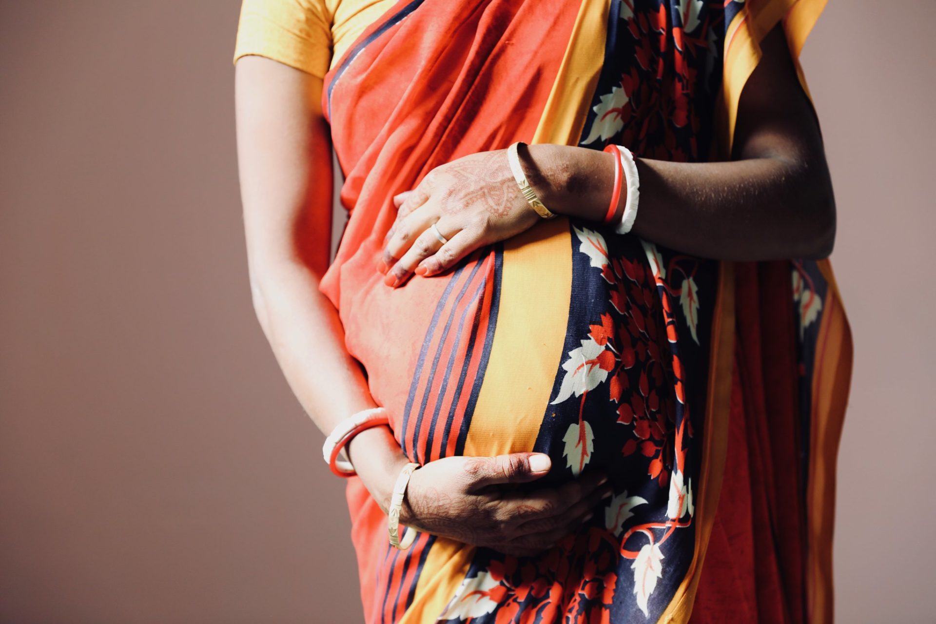 Pregnant Woman in Nepal Holding Her Belly