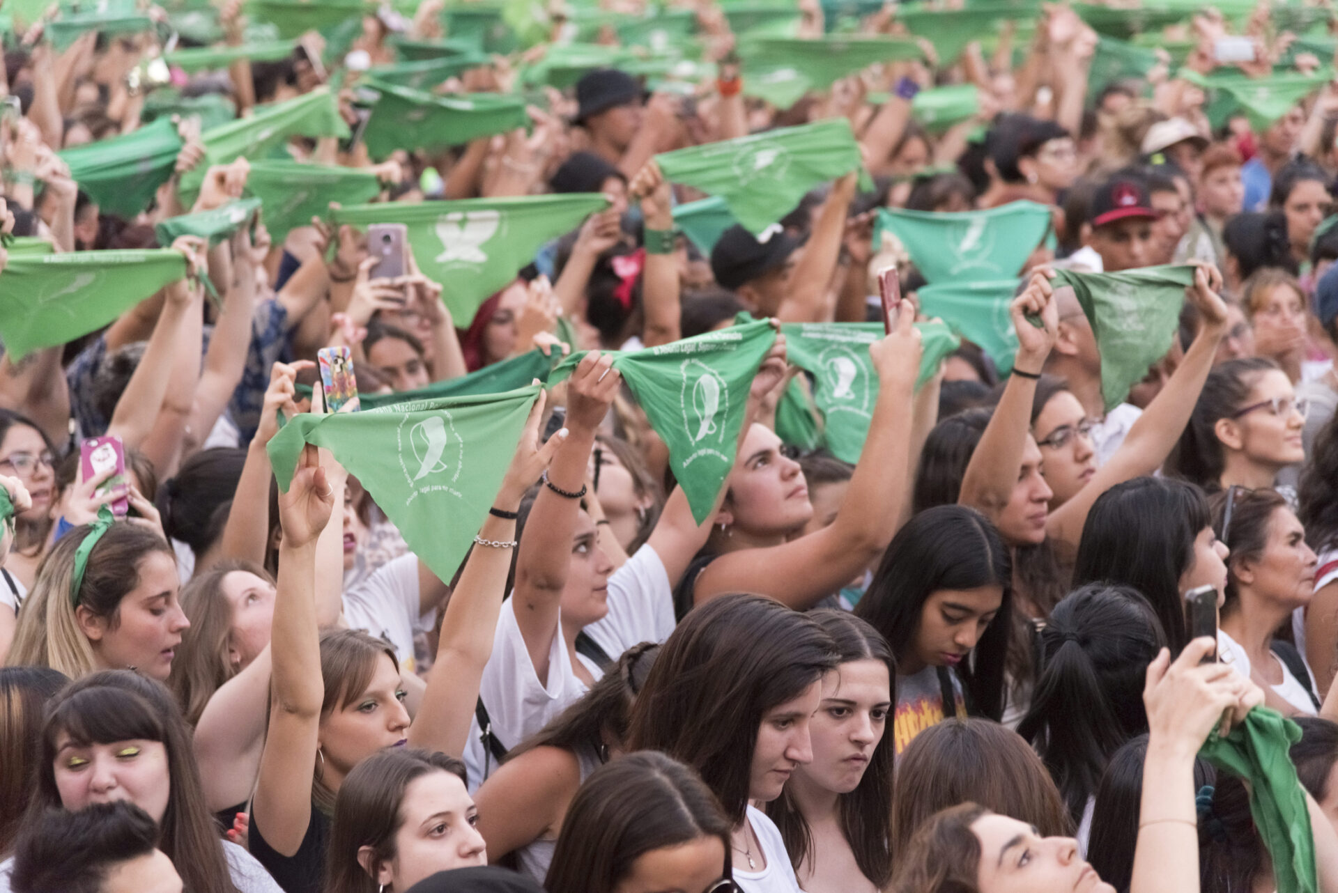 Capital Federal, Buenos Aires / Argentina; Feb 19, 2020: Women at a rally raise green handkerchiefs, a symbol of support for legal, safe, and free abortion in Latin America. 