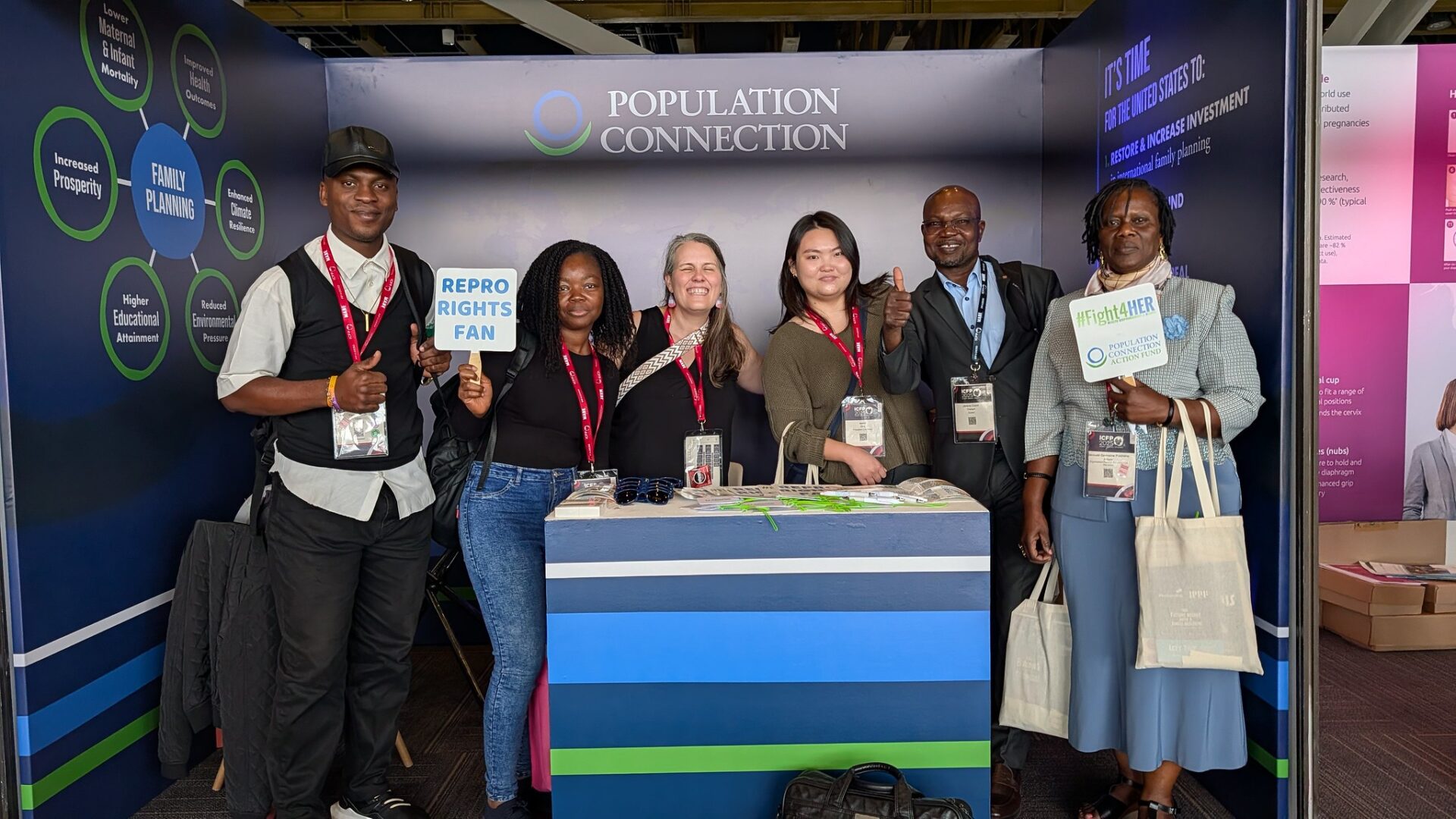 Rebecca and Isabel with booth visitors at ICFP.